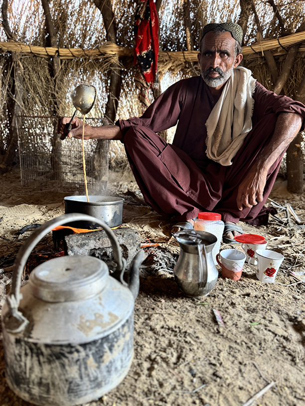 Goat keeper in Pakistan preparing tea.