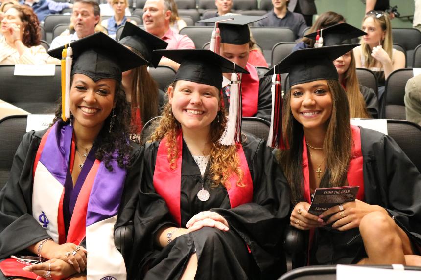 Students smiling at graduation