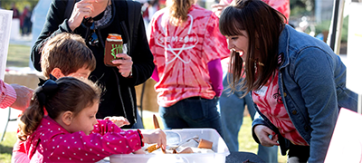 Students interact with visitors at the anthropology tent during the STEMzone interactive event before the UGA vs. Missouri football game.