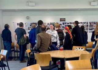 a group of people gathered around a photo gallery