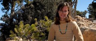 Sarah Hitchner outdoors with mountain, scrub background