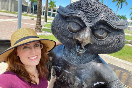 Katharine Napora standing next to Florida Atlantic University mascot statue