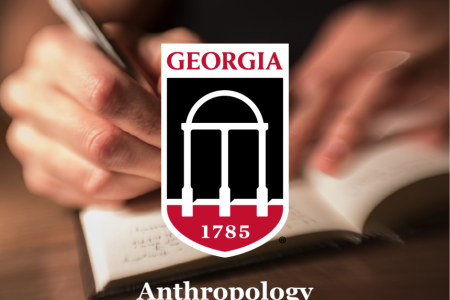 close up shot of hands writing under UGA logo