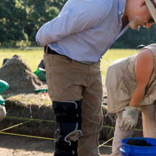Professor Victor Thompson works with undergraduate student Katelyn Leka as they work on the excavation of their site.